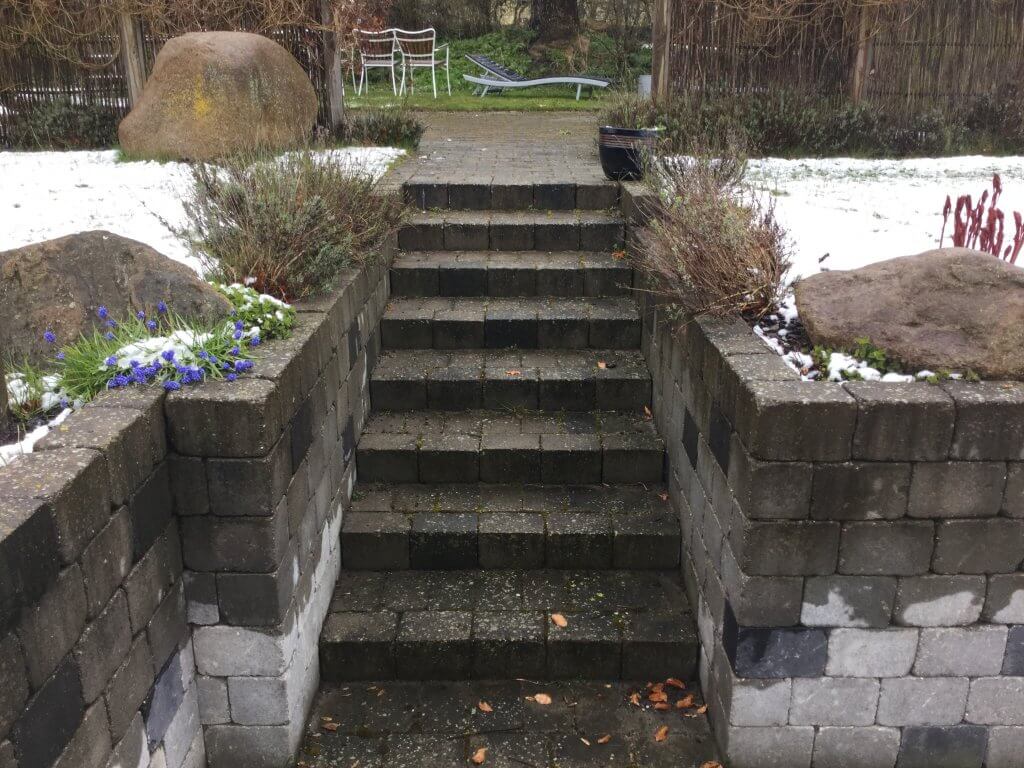 outdoor steps slippery block paving with green moss