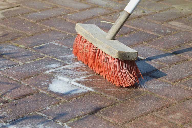 Patio Cleaning With Broom And Bleach